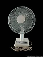 Front view of vintage 12-inch desk fan showing metal blade guard, control panel on base with 3 speed settings, and attached power cord.