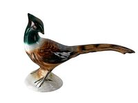 Side angle view of porcelain pheasant figurine showing detail of bird's head, body, and tail with naturalistic coloring.