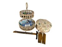 Two-tier round woven basket filled with assorted sewing supplies and a wooden/metal shoe sizer with yellow measurement markings and black sliding indicator, plus floral fabric pin cushion.