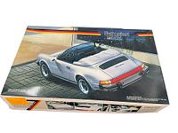Closed box showing color illustration of Porsche 911 Turbo model on lid, with red, black, and yellow lines.
