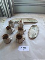 Full set of pottery items shown from above on white background, includes all 8 pieces.