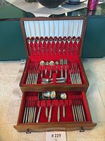 Closed wooden flatware chest with keyhole and side clasps