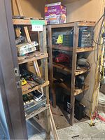 Two wooden shelving units in a storage shed with assorted tools and part organizers visible. Shelves are not included in lot.