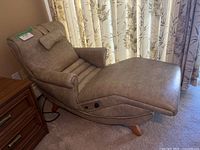 Profile view of the extended power lounger showing overall design, upholstery condition, and rocker base.