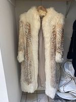 Front view of coat showing full-length fur and lining