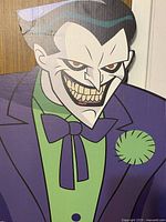 Close-up photo of The Joker's face on the cardboard cutout showing detailed animated features and paint colors.