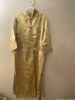 Full vintage Asian silk kimono displayed on a hanger, showing full length and sleeve details.