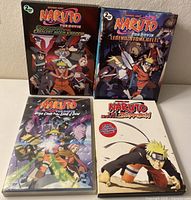 Four Naruto Shippuden DVD movies displayed, showing colorful anime cover artwork for each movie.
