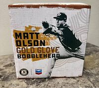 Front side of box showing Matt Olson Gold Glove Bobblehead text and logos.