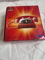 Box showing back with labeled photo key for phone features and The Incredibles branding, and SBC logo.