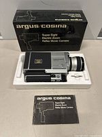 Front view of the Argus Cosina Super Eight Movie Camera in its original packaging along with the box and manual.