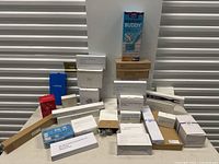 Full lot overview showing multiple boxed items arranged on a table, all appearing new and in original packaging.