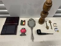 Full view of the lot showing all items together including wooden pepper grinder, keys, pipe, mirror, lighters, and wooden box.