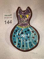 Top view of the cat-shaped spoon rest showing colorful decoration and glossy finish.