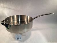 Side view of the stainless steel sauté pan showing the long handle and side grip handle.