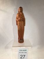 Front view of the vintage hand carved wooden Virgin Mary and Baby Jesus sculpture on a white background.