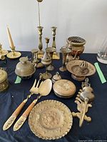 Overview of all brass and cloisonné items on black cloth