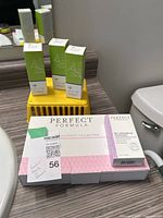 Wide shot of septum nail product boxes with Gundry MD products in plastic basket, Perfect Formula nail treatment collection box and My Favorite Topcoat box in foreground