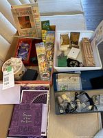 Overview of books, card decks, decorative tin, divination blocks, pendants and charms