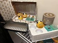 View of full set including Torricelumn Absolute Body Cream, Vitamin C5 Night Cream, Renewal Night Serum, and Revitalizing Day Serum in their packaging and trays.