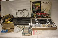 Full set laid out showing original box, tray insert, track pieces, controllers, loop rings, supports, manual and small parts box