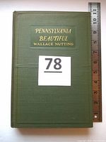Front cover of the green hardback book with gold embossed title 'PENNSYLVANIA BEAUTIFUL WALLACE NUTTING' alongside a ruler showing the book size.