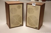 Pair of Lafayette Criterion 3X speakers with grills attached, showing wood cabinets and overall good cosmetic condition.