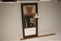 Framed piece upright, showing print and mirror panels with scale ruler at base