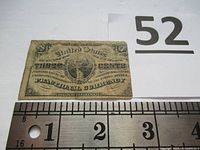 Front side of shinplaster showing George Washington portrait and denomination three cents with measuring scale.