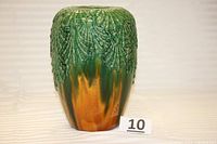 Full view of vintage majolica jardiniere vase showing shell relief and green-brown glaze