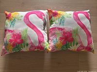 Front view of two flamingo print pillows showing design and colors