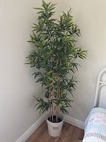 Entire potted artificial plant in room corner