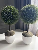 Both artificial topiary plants in pots