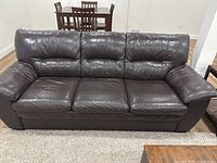 Front view of entire dark brown leather sofa