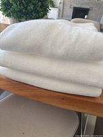 Stack of white bath towels on chair