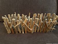 Full view of driftwood candle holder showing twig frame and four glass votive cups