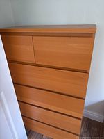 Front view of tall six-drawer dresser