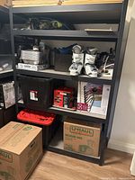 Front view of shelving unit with contents present for scale