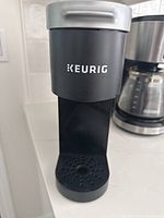 Front view of black Keurig K-Mini with logo and drip tray visible