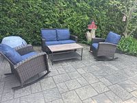 Full set showing loveseat, two rockers, coffee table