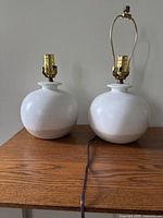 Two ceramic lamps on wood surface
