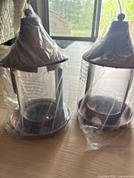 Both packaged bird feeders side by side on floor