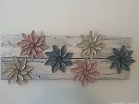 Full view of wooden wall art showing six flowers