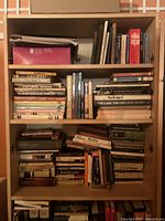 Bookshelf filled with assorted vintage books of multiple genres and sizes
