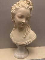 Front view of full bust on round pedestal base