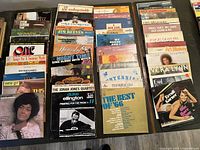 Top-down view of multiple vinyl LP records arranged in rows showing cover art and artist names.