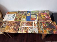 Top-down view of eight vintage Walter Foster art books arranged on a flat surface showing colorful illustrated covers.
