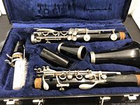 Disassembled clarinet parts laid out in blue plush case