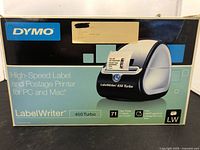 Front view of the DYMO LabelWriter 450 Turbo box showing brand, model, and key features like print speed and compatibility.