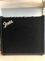 Front black grille of Fender Mustang LT25 amplifier with Fender logo.